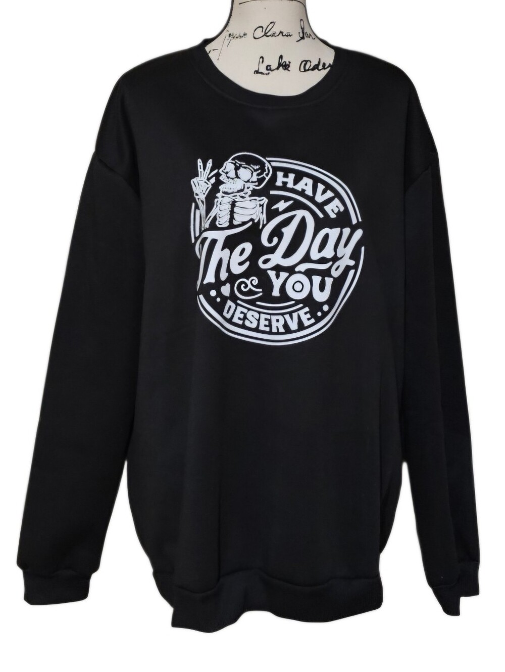 Black Graphic Sweatshirt with White 'Have The Day You Deserve' Skull Design